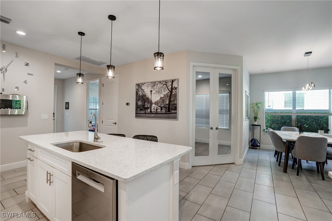 7028 Mistral Way Fort Myers, FL 33966 - Photo 10 of 37 a kitchen with a sink a counter space and a chandelier