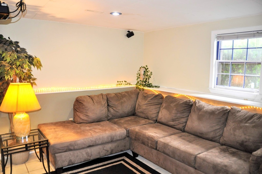 16 Gove Road Billerica, MA 01821 - Photo 24 of 30 a living room with furniture and a lamp