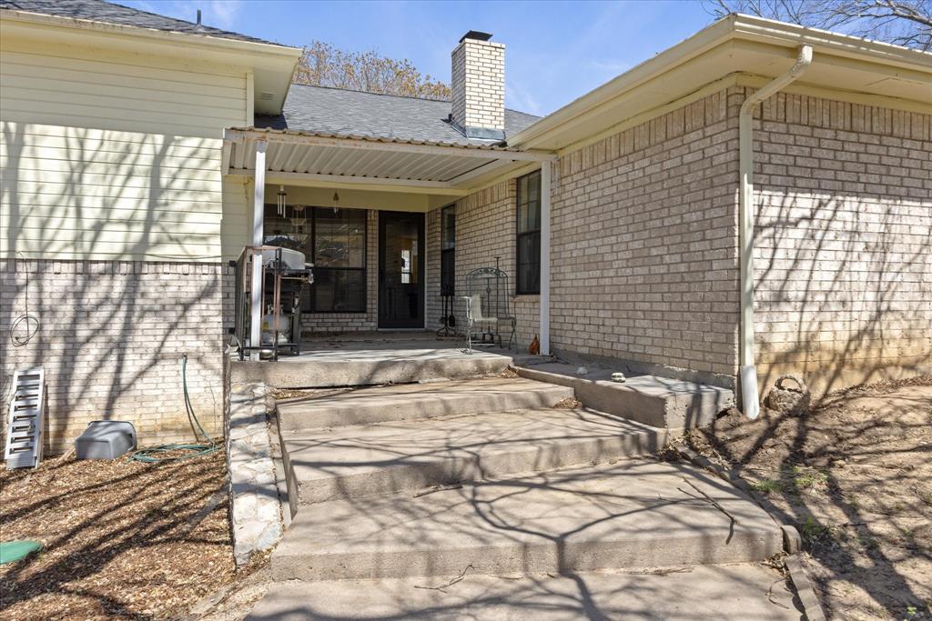 1701 Hitching Post Road Granbury, TX 76049 - Photo 24 of 37 Patio off French doors in living room