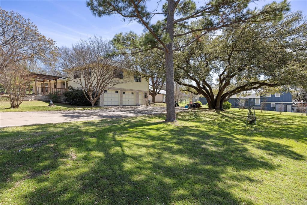 1701 Hitching Post Road Granbury, TX 76049 - Photo 3 of 37 This is the lower driveway side, with a several hundred year old live oak