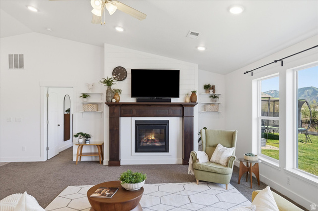 1422 West 3410th Street South Logan, UT 84321 - Photo 5 of 33 Living area featuring a fireplace with a dark wood mantel and shiplap accent wall