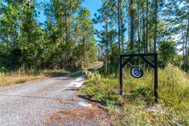 a backyard of a house with a yard and outdoor seating