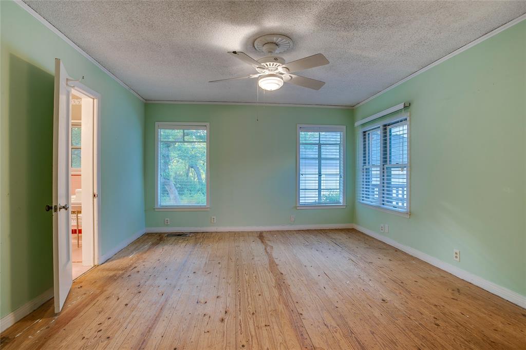 1439 Jr Drive Dallas, TX 75208 - Photo 17 of 39 a view of an empty room with wooden floor and a window