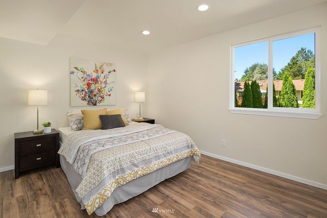 a bedroom with a bed and a painting on the wall