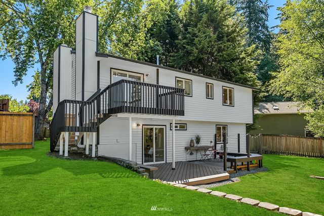 a view of a house with a yard and sitting area