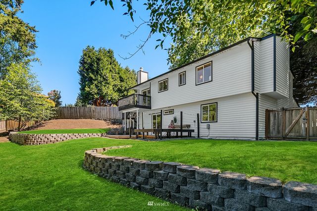 a view of a house with a yard and sitting area