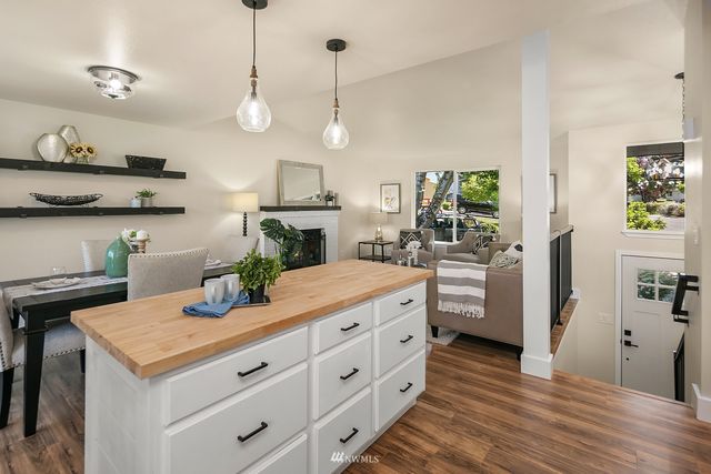 a kitchen with stainless steel appliances kitchen island a large island in the center and wooden floor