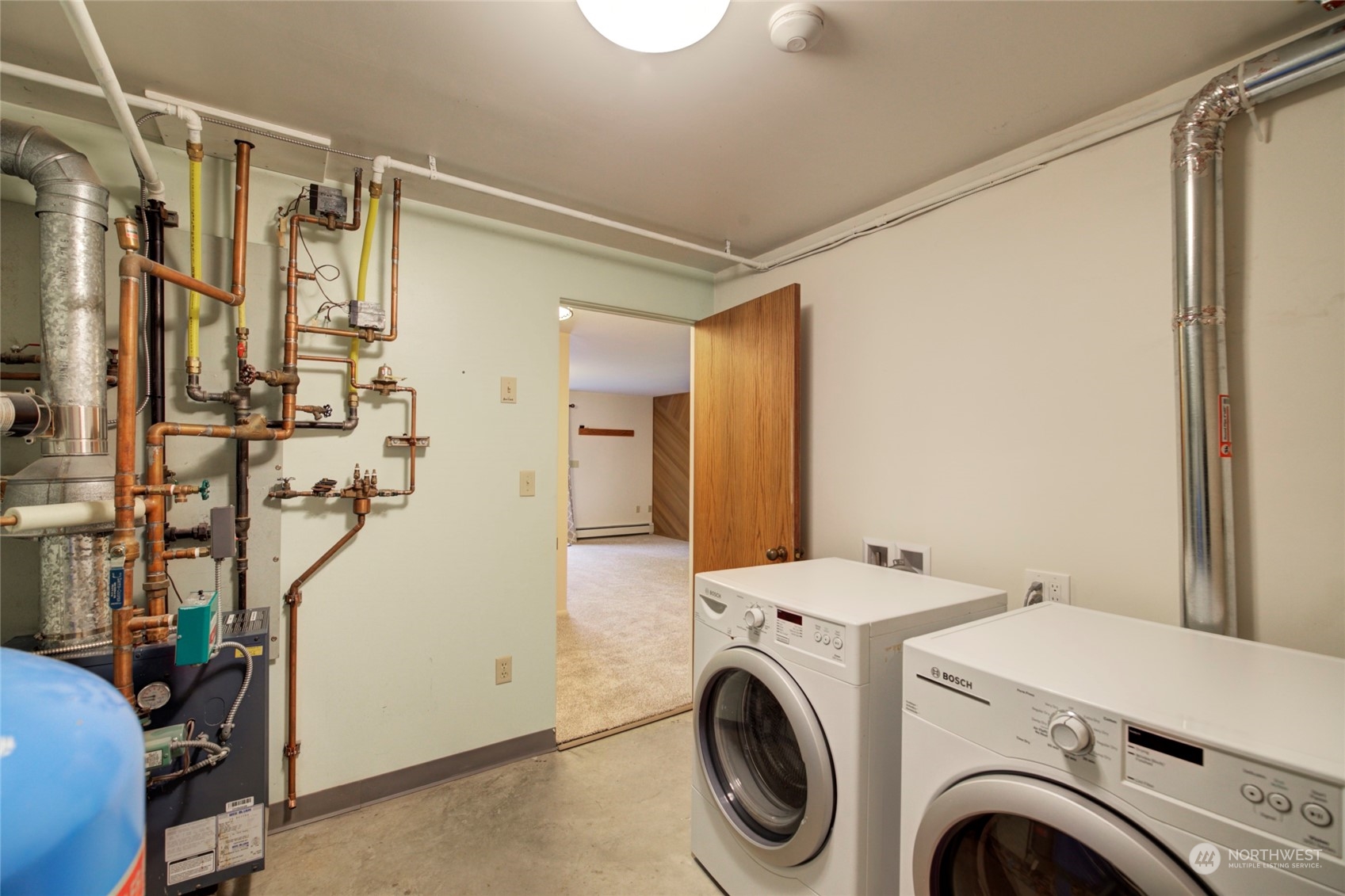 24300 7th Place West Bothell, WA 98021 - Photo 36 of 40 a view of storage and utility room with washer and dryer