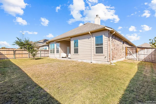 a view of a house with a backyard