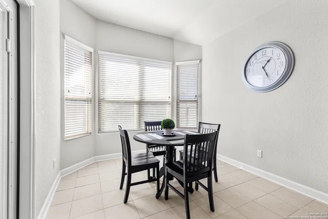 a view of a dining room with furniture and a window