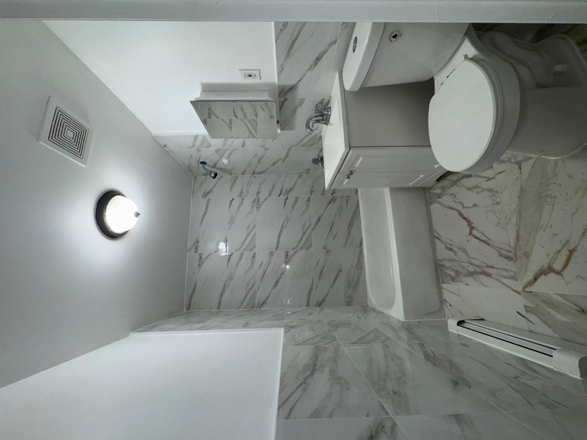 631 Coster Street Bronx, NY 10474 - Photo 12 of 19 a bathroom with a toilet a sink and bathtub