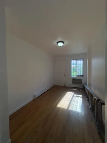 a view of wooden floor and windows in a room