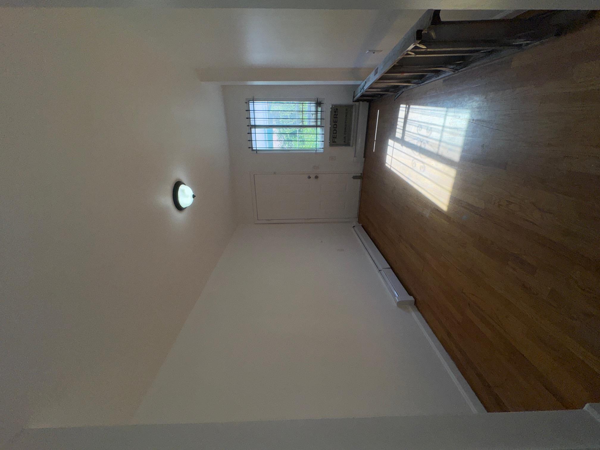 631 Coster Street Bronx, NY 10474 - Photo 15 of 19 a view of wooden floor and windows in a room
