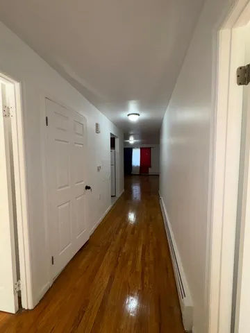 a view of gallery with wooden floor