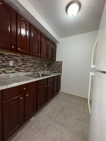 a kitchen with stainless steel appliances granite countertop wooden cabinets a sink and dishwasher