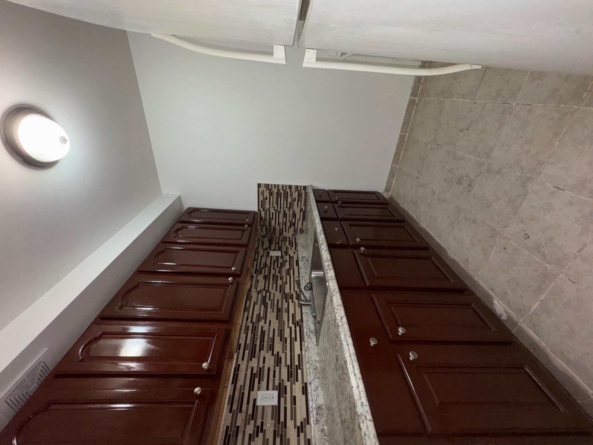 631 Coster Street Bronx, NY 10474 - Photo 10 of 19 a kitchen with stainless steel appliances granite countertop wooden cabinets a sink and dishwasher