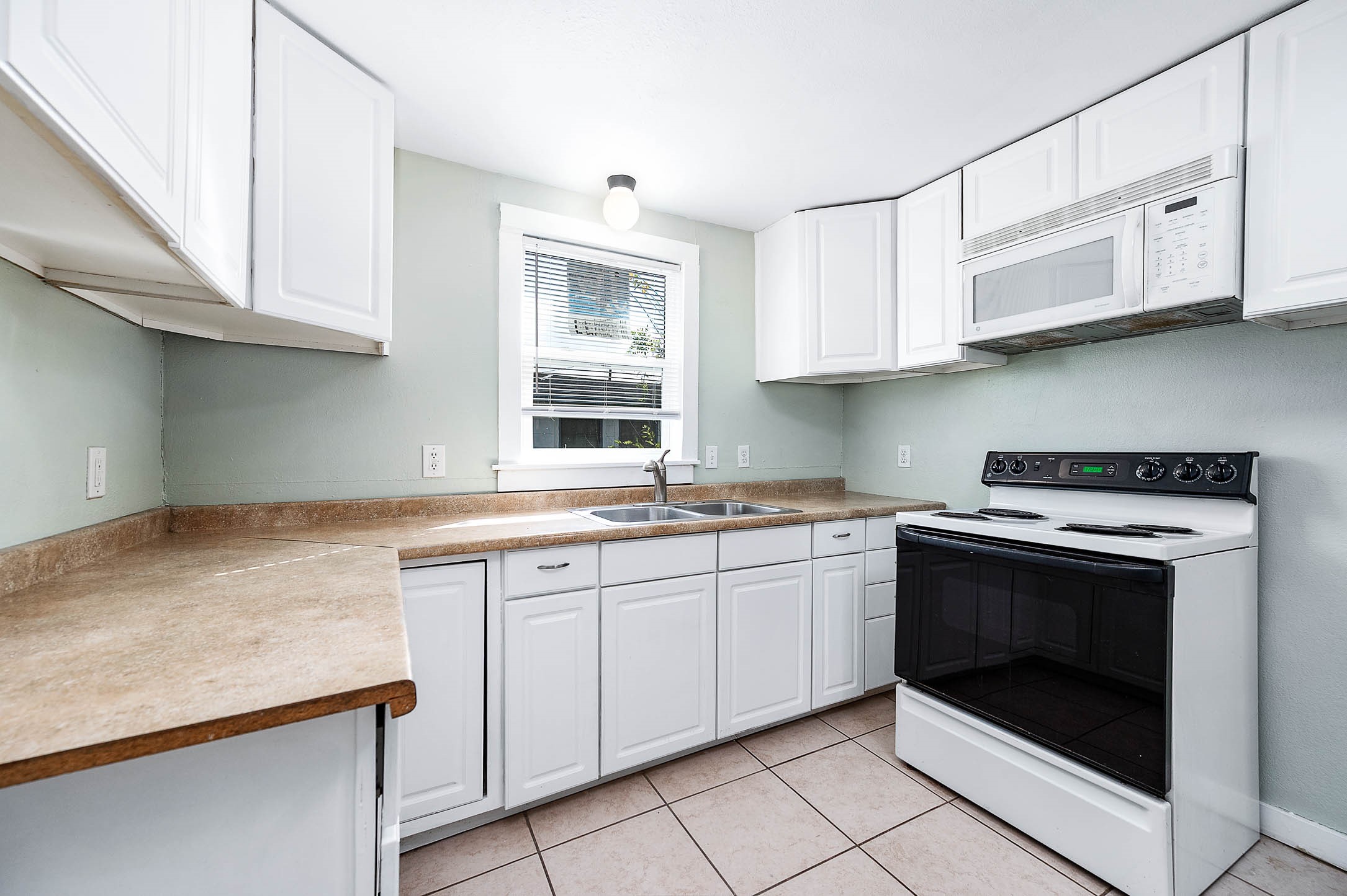 2012 Avenue F Dickinson, TX 77539 - Photo 11 of 20 a kitchen with stainless steel appliances granite countertop a stove sink and cabinets