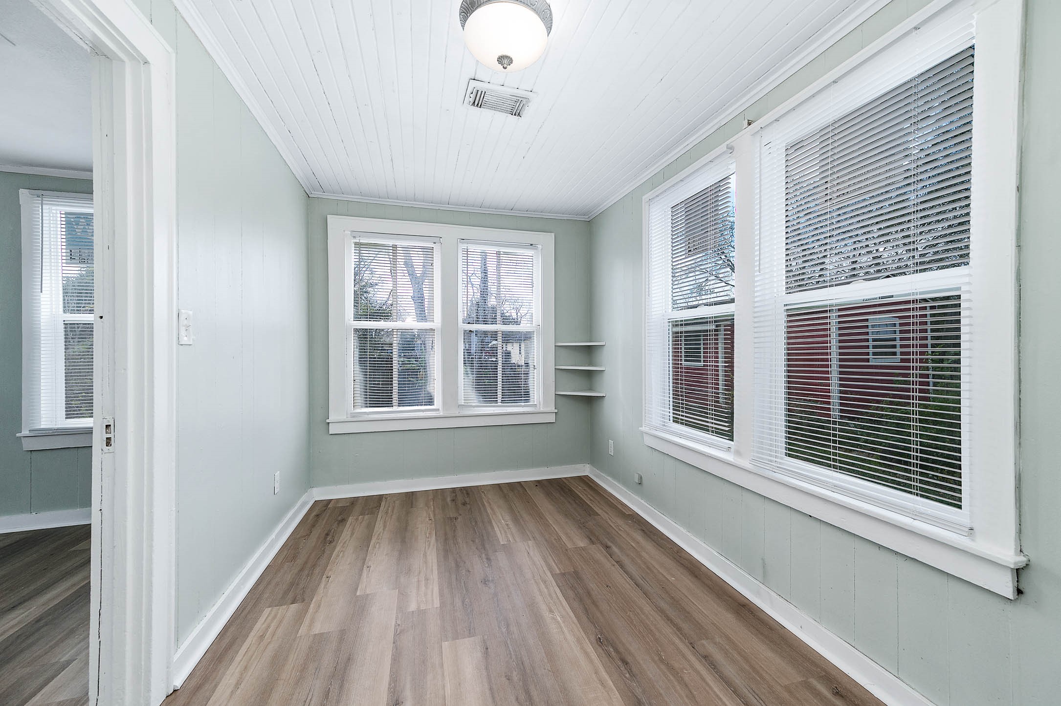2012 Avenue F Dickinson, TX 77539 - Photo 14 of 20 a view of an empty room with wooden floor and a window