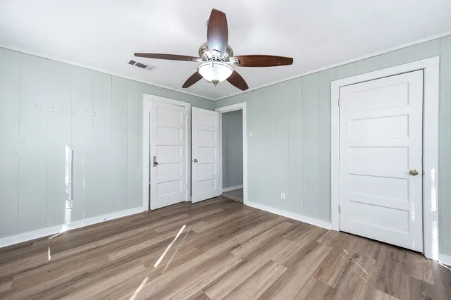 a view of a house with backyard and a tree