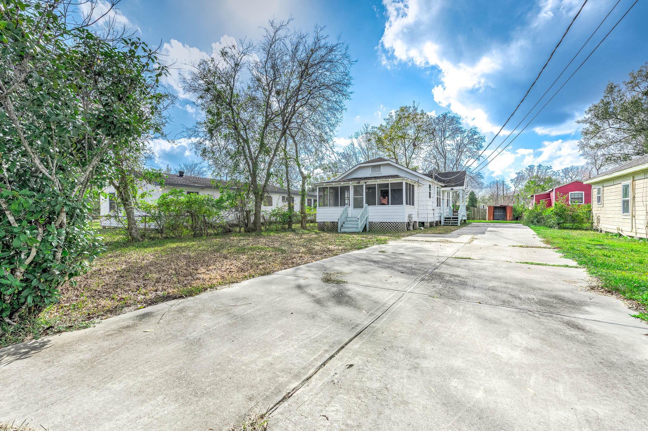 2012 Avenue F Dickinson, TX 77539 - Photo 3 of 20 a front view of a house with a yard and potted plants
