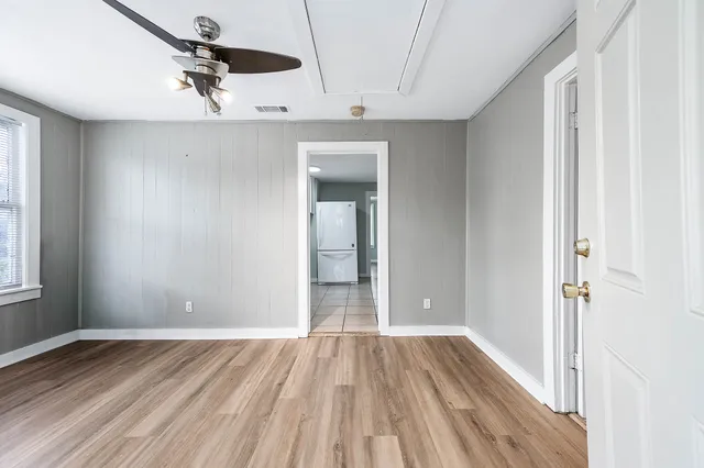 wooden floor in an empty room with a window