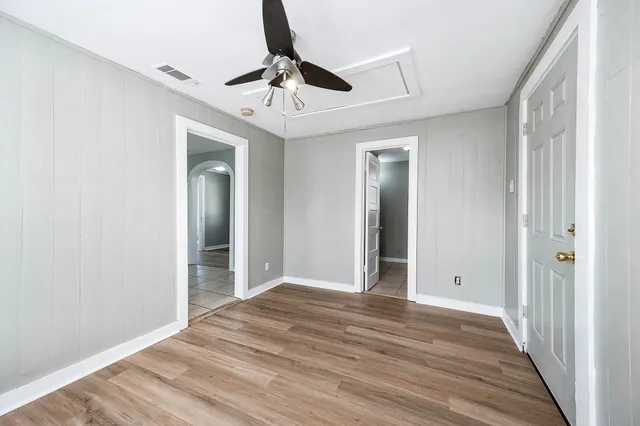 a view of an empty room with wooden floor