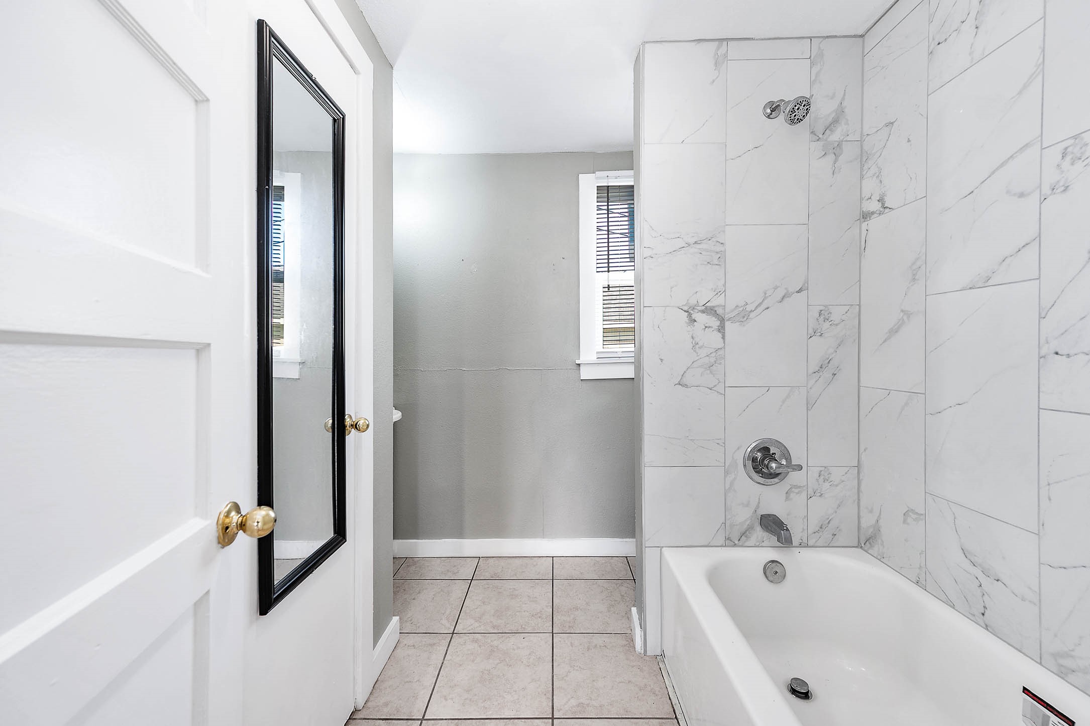 2012 Avenue F Dickinson, TX 77539 - Photo 8 of 20 a bathroom with a bathtub and shower