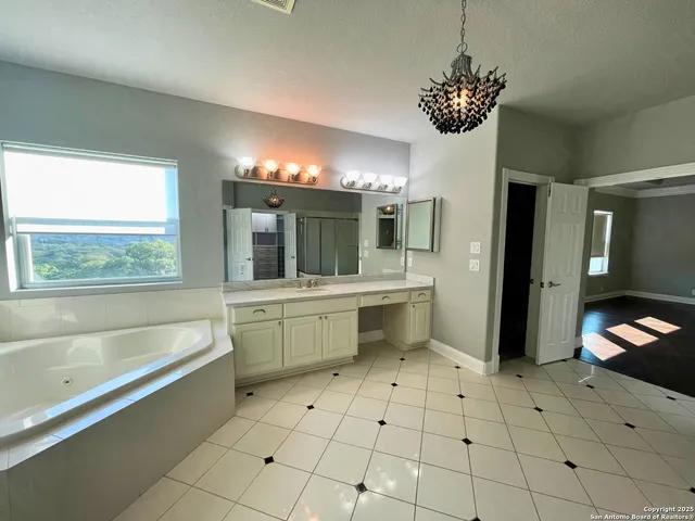 a bathroom with a sink a toilet a mirror and bathtub