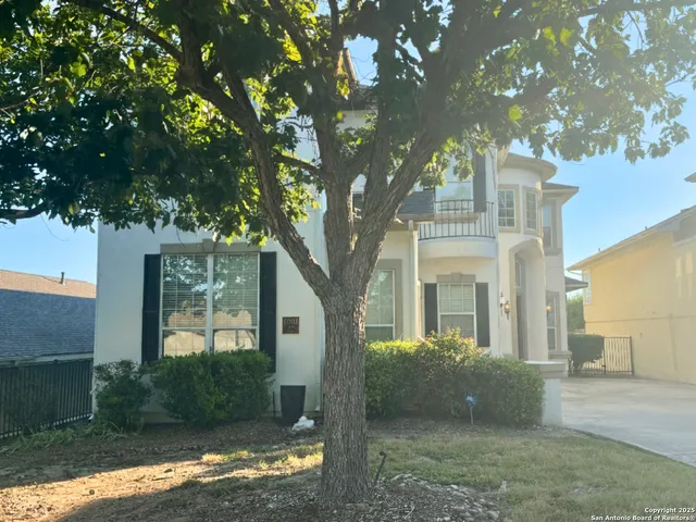 a view of a front of a house with a tree