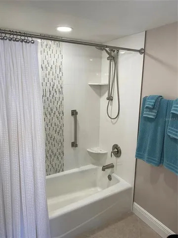 a bathroom with a bath tub and a shower