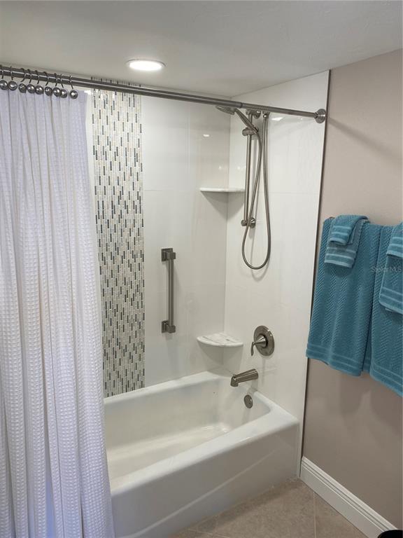 631 Alhambra Road, Unit 702 Venice, FL 34285 - Photo 11 of 14 a bathroom with a bath tub and a shower