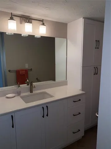 a bathroom with a sink and mirror