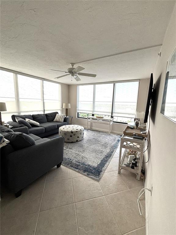 631 Alhambra Road, Unit 702 Venice, FL 34285 - Photo 4 of 14 a living room with furniture window and a flat screen tv