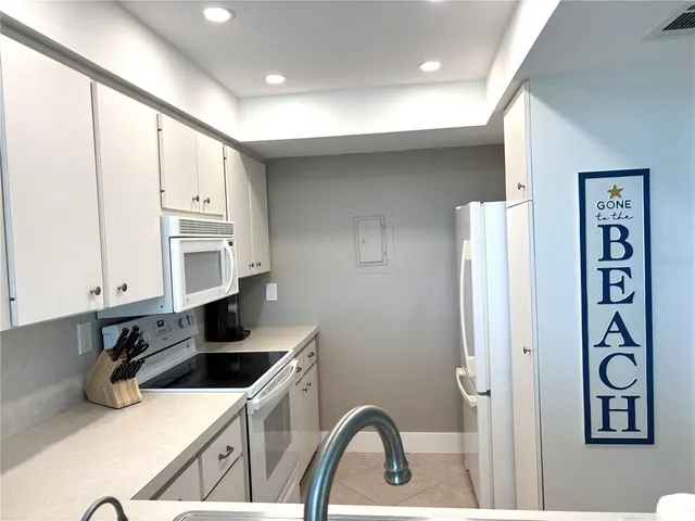 a kitchen with stainless steel appliances a sink a stove and a refrigerator