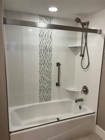 a bathroom with a shower and a bathtub