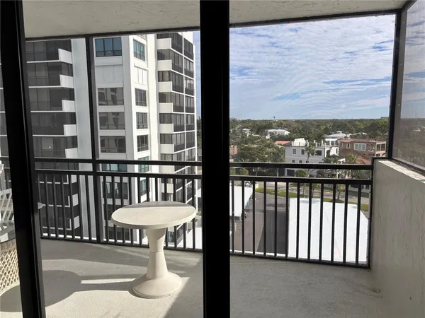 a view of a balcony with chair and a floor to ceiling window