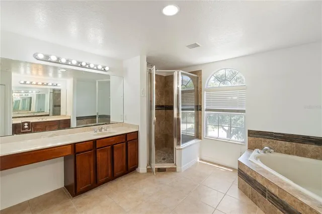an empty room with wooden floor and window