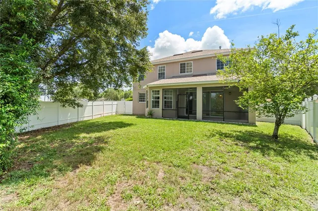 a view of a living room a hardwood floor and a ceiling fan