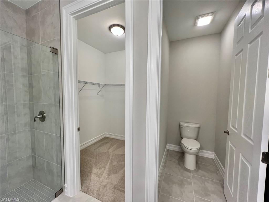 842 Enbrook Loop Naples, FL 34114 - Photo 11 of 23 a bathroom with a granite countertop toilet