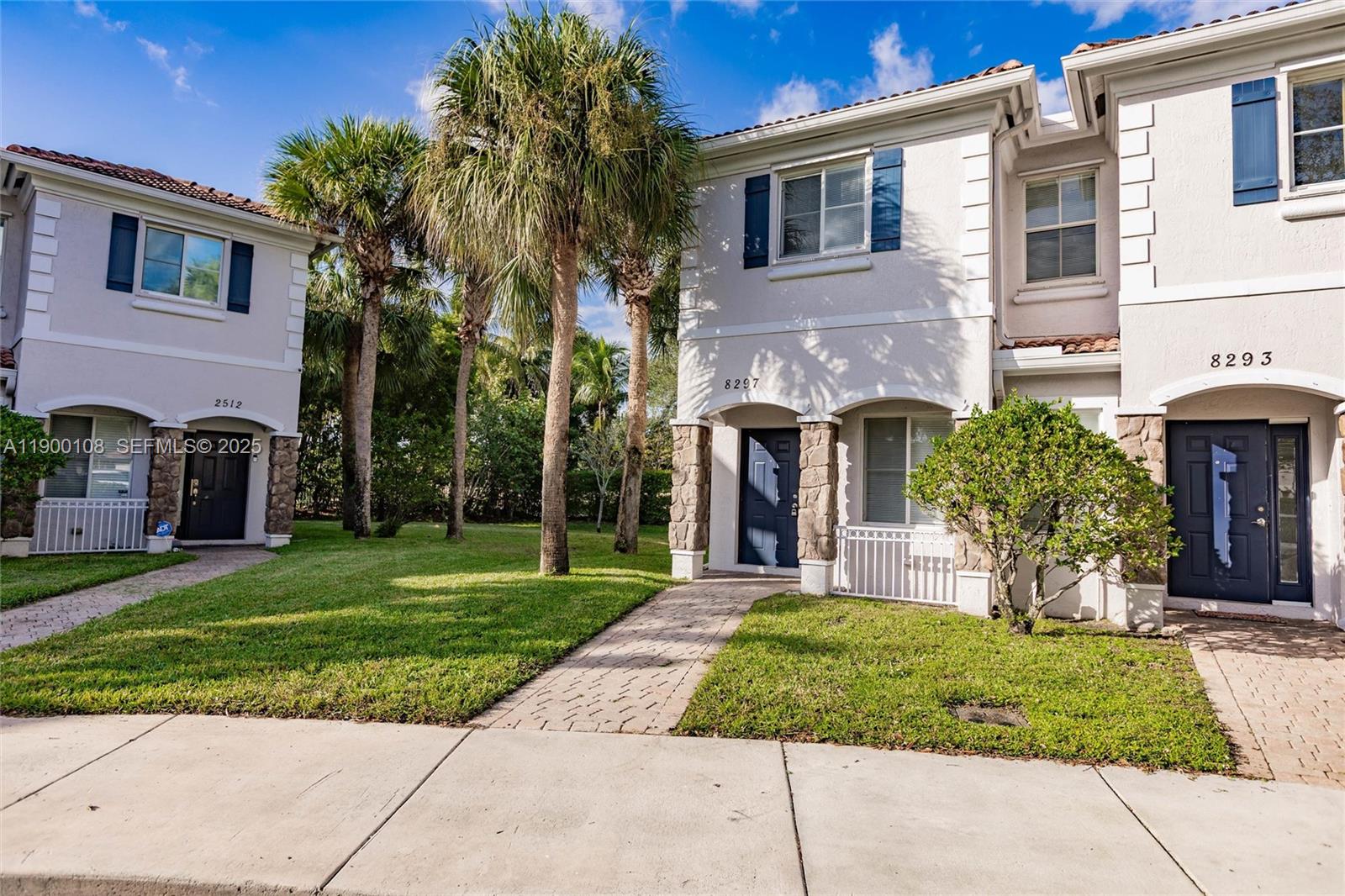 a front view of a house with a garden and plants