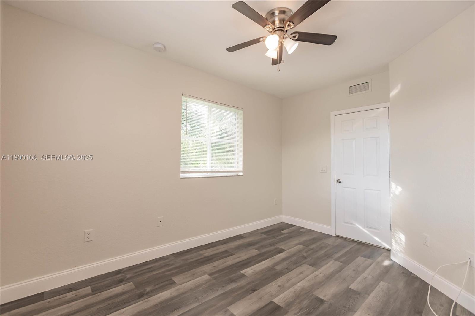 8297 Southwest 25th Court, Unit 101 Miramar, FL 33025 - Photo 21 of 42 an empty room with a window and a fan