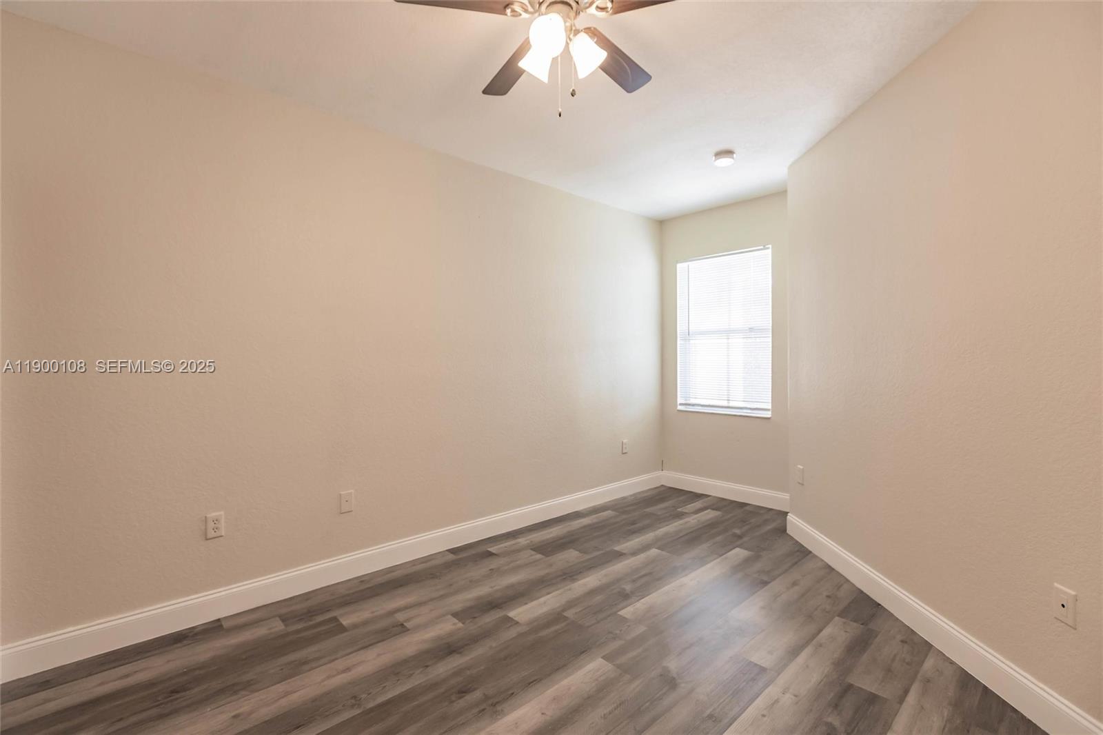 8297 Southwest 25th Court, Unit 101 Miramar, FL 33025 - Photo 23 of 42 wooden floor in an empty room with a window