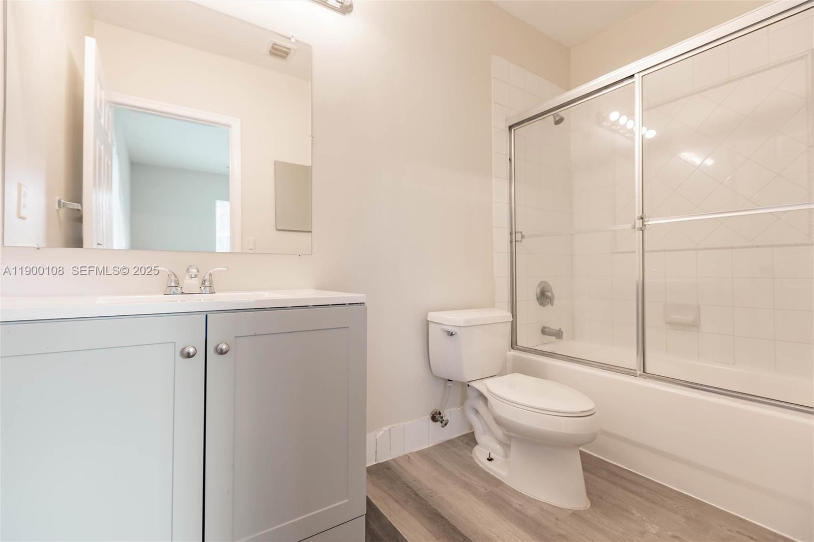 8297 Southwest 25th Court, Unit 101 Miramar, FL 33025 - Photo 29 of 42 a bathroom with a toilet sink vanity and shower