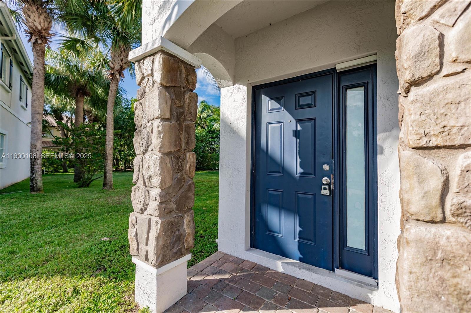 8297 Southwest 25th Court, Unit 101 Miramar, FL 33025 - Photo 3 of 42 a front view of a house with a garden