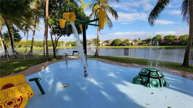 a view of swimming pool with a table and chairs
