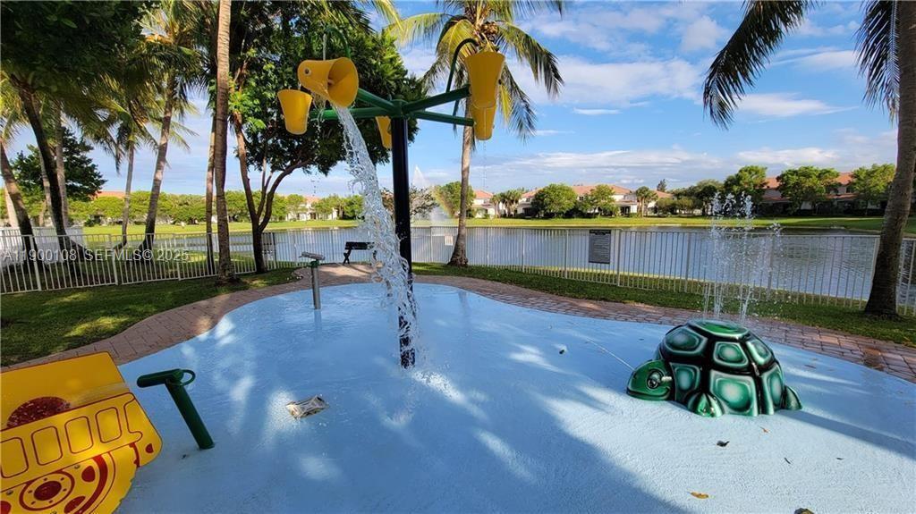 8297 Southwest 25th Court, Unit 101 Miramar, FL 33025 - Photo 36 of 42 a park with lots of palm trees and lake view