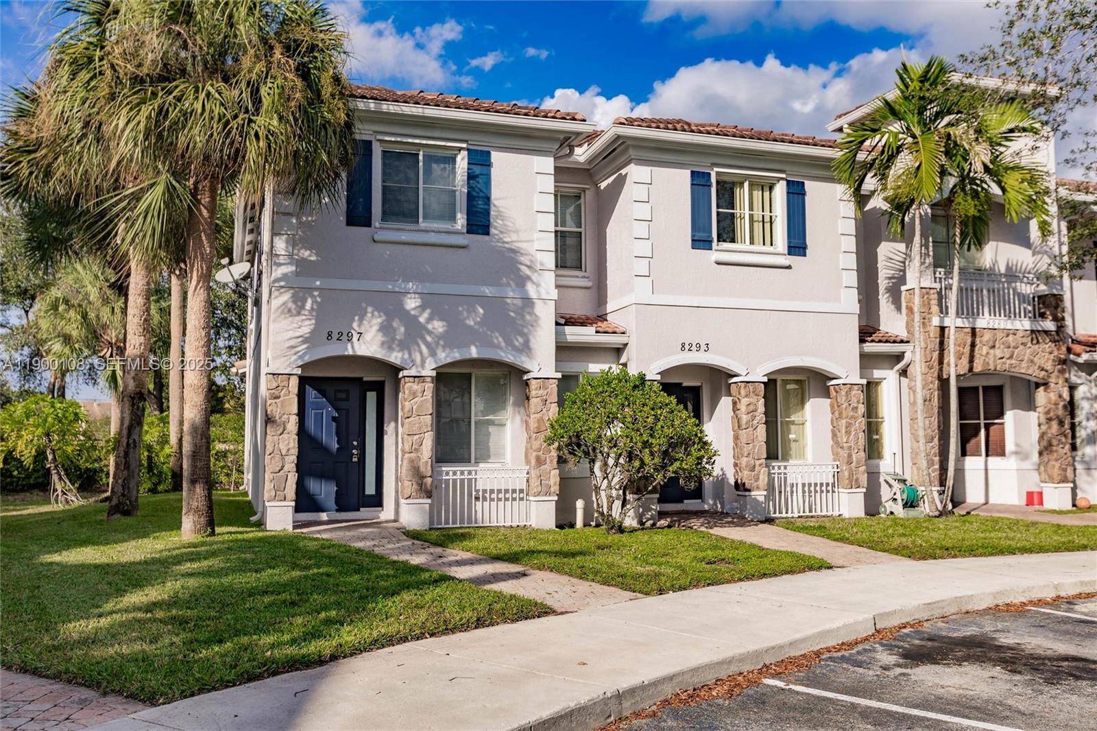 8297 Southwest 25th Court, Unit 101 Miramar, FL 33025 - Photo 42 of 42 a front view of a house with a garden and trees