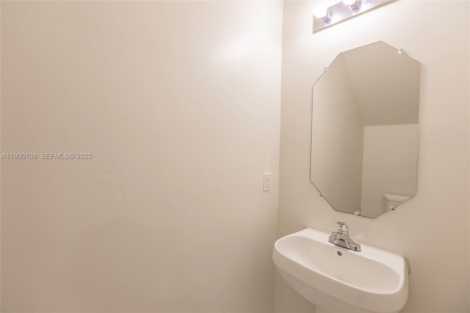 8297 Southwest 25th Court, Unit 101 Miramar, FL 33025 - Photo 8 of 42 a bathroom with a sink and a mirror