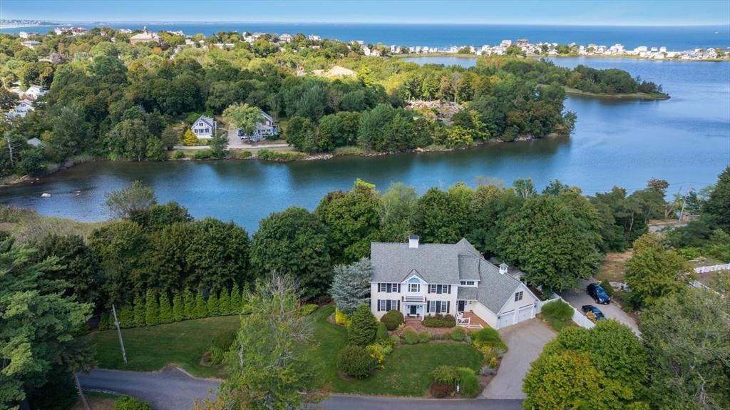 an aerial view of a house with a yard lake view and mountain view