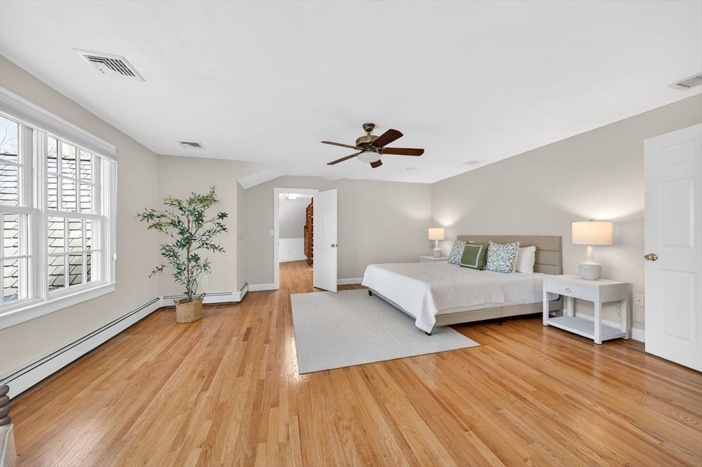 792 A Jerusalem Road Cohasset, MA 02025 - Photo 25 of 42 a bedroom with a large bed and a chandelier
